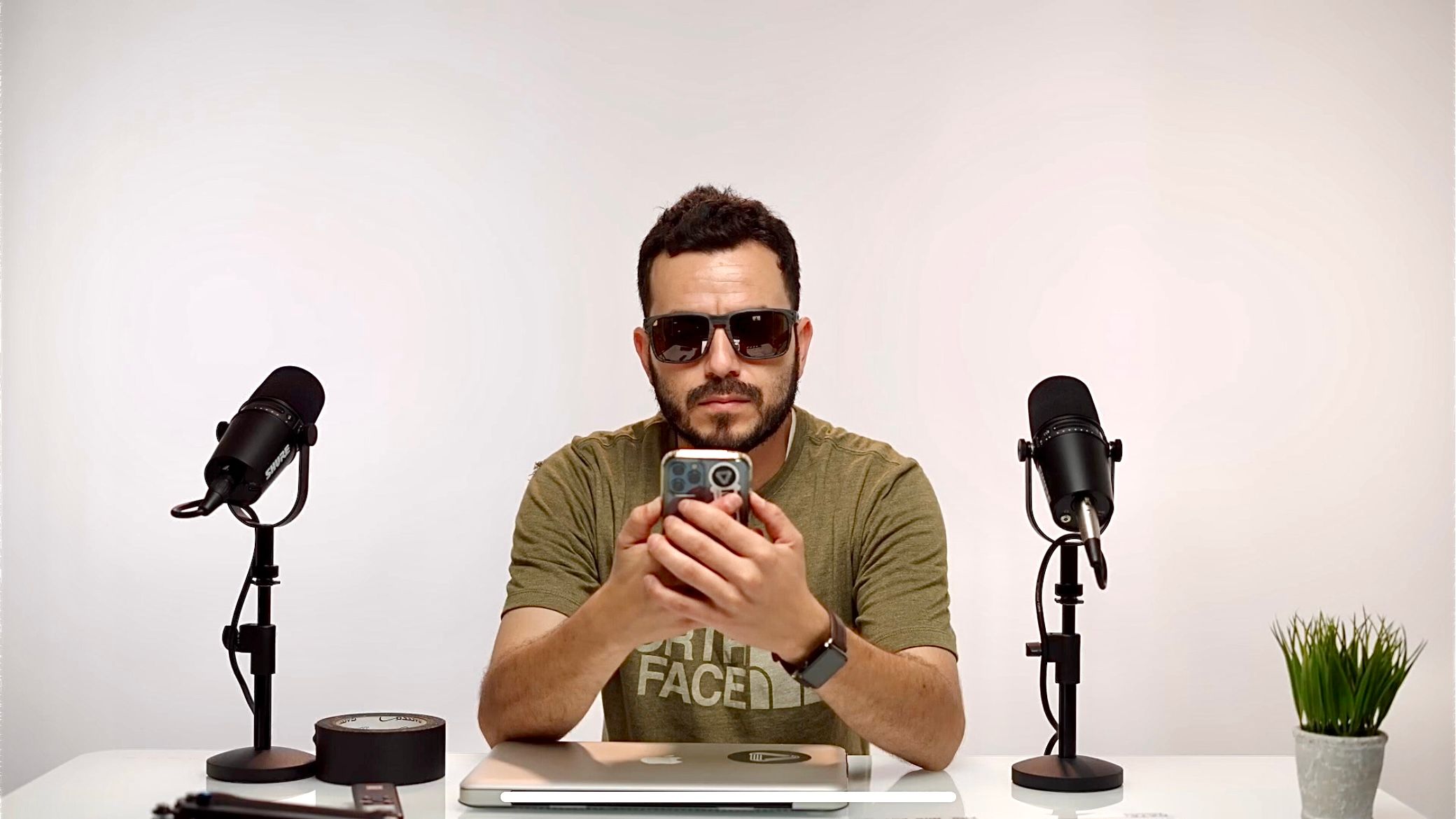 A man recording a podcast with a microphone and headphones.
