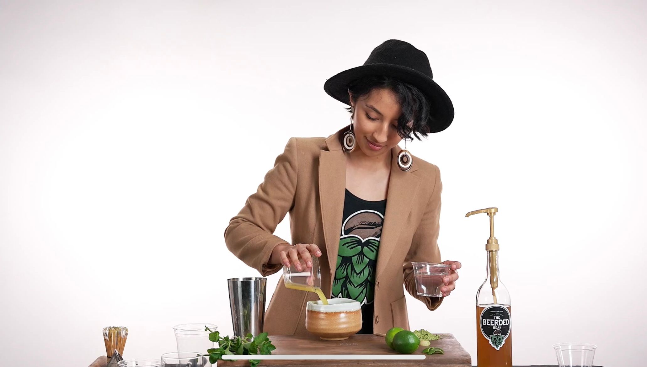 A young woman pouring coffee into a mug, captured in a snapshot from a video production by Media Knowledge Group for a coffee company.