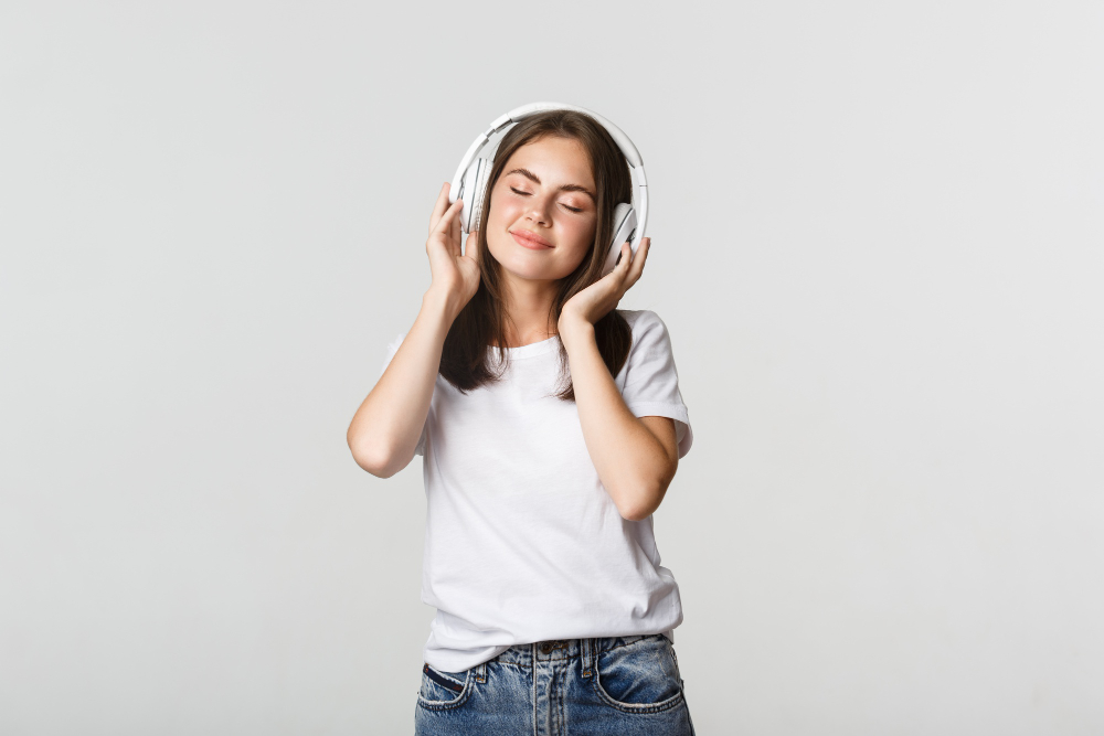 Person wearing headphones to emphasize sound-free viewing.