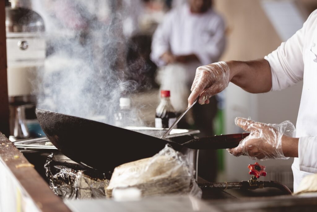 Talented chef cooking a delicious dish with a pot.