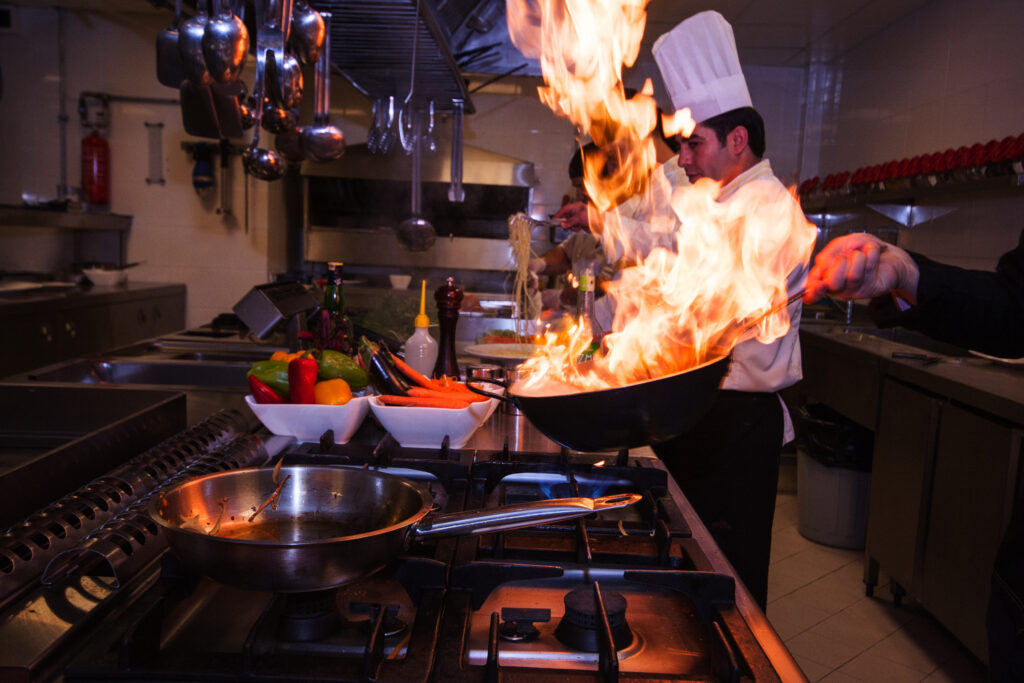 Talented chef expertly preparing a dish, showcasing precision and culinary skills